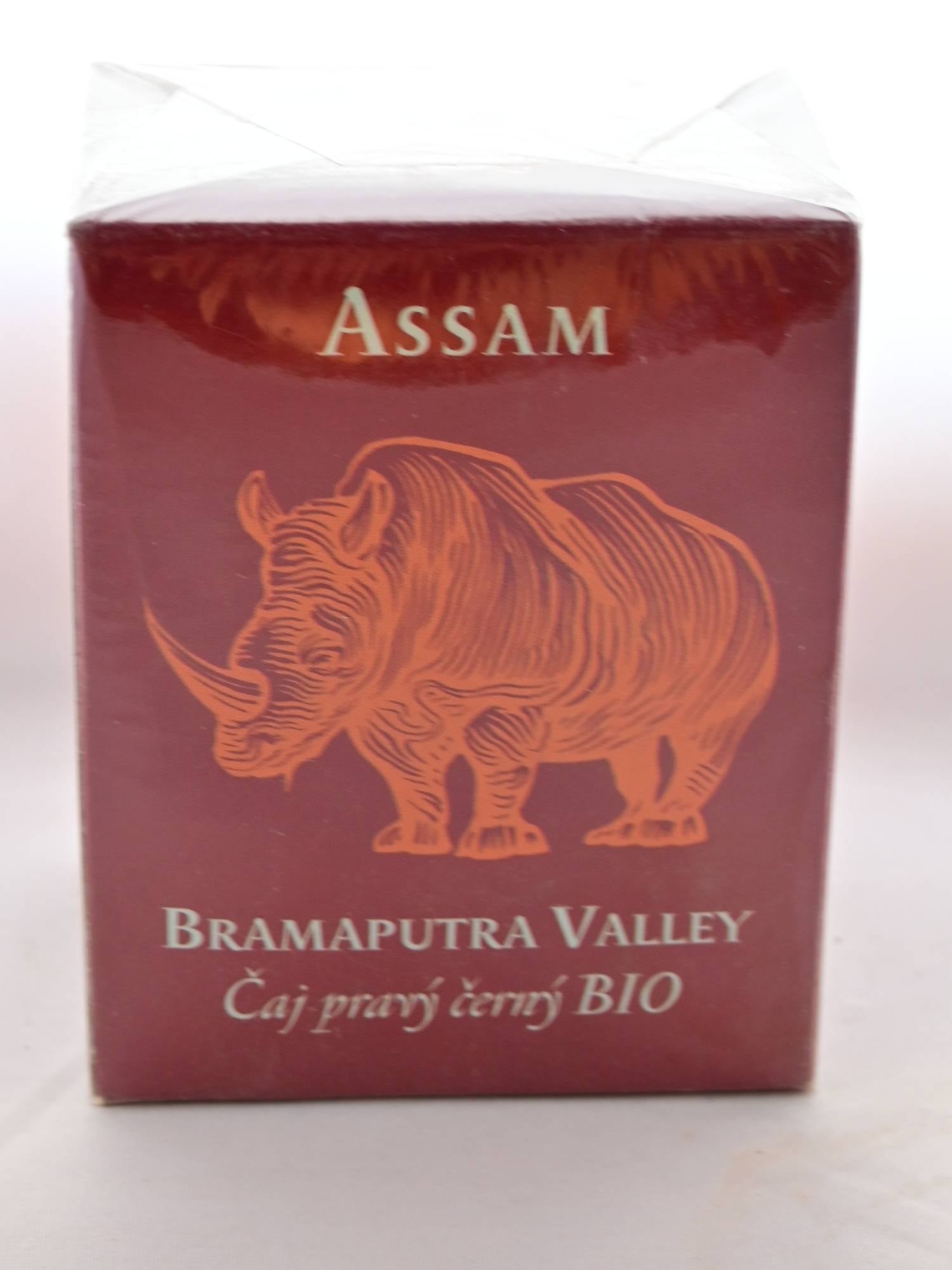 The Assam Brahmaputra box is a squat, red cube with an orange rhino on the front. White text reads: "Assam. Brahmaputra Valley." Czech lettering is below the English writing.