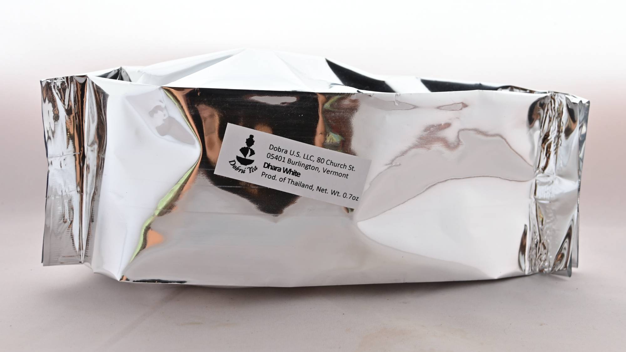 The Dhara White Tea package is pure silver, with a descriptive Dobra Tea label in white on the side.