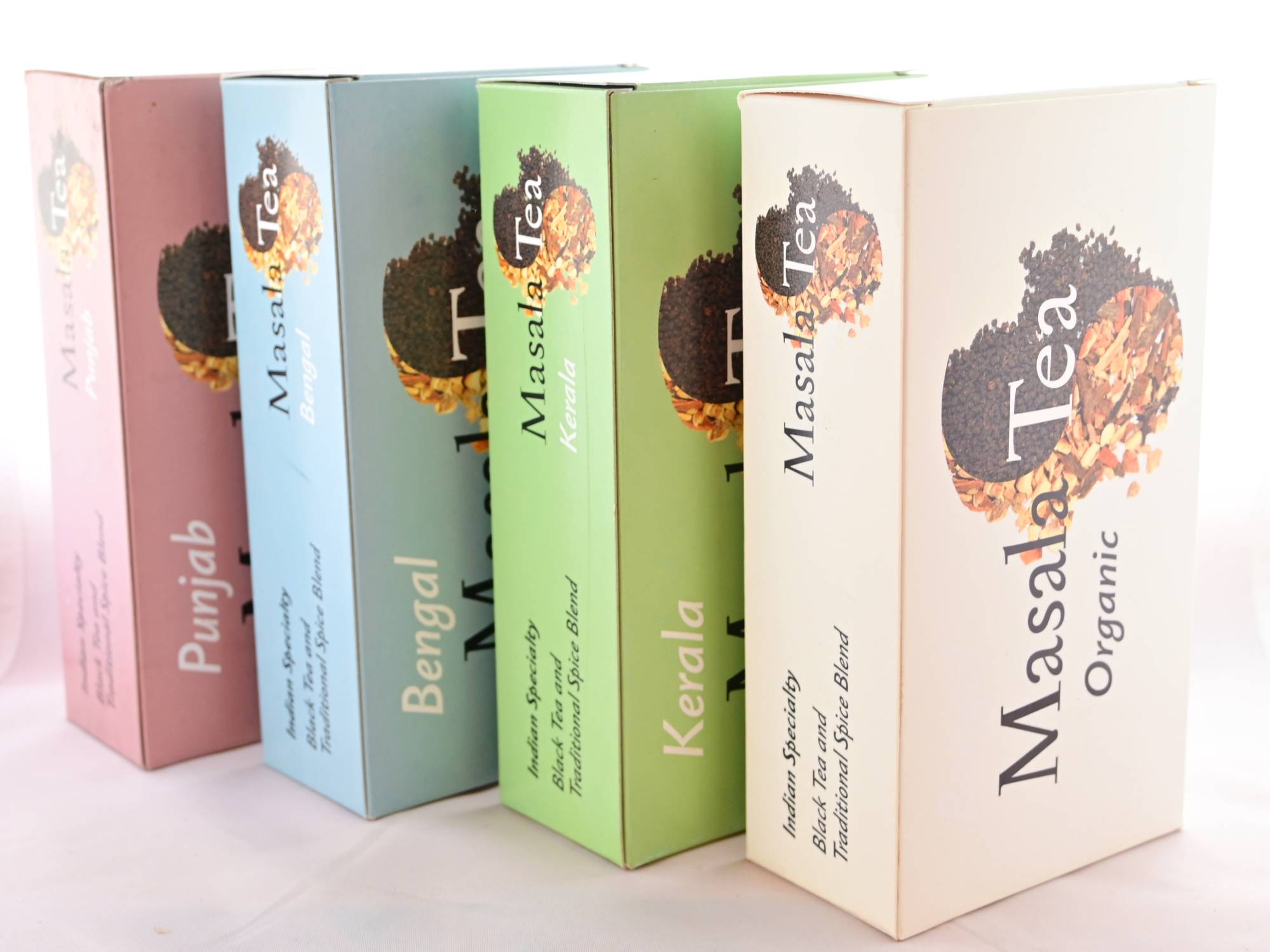 Four boxes standing on their sides facing upwards. From left to right, text reads: "Punjab, Bengal, Kerala, Masala Tea Organic."