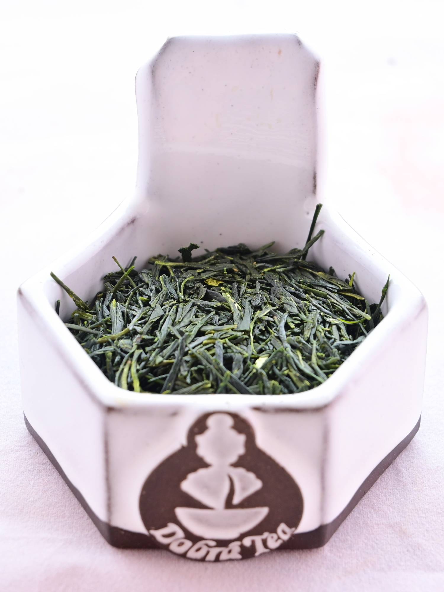 A close-up of Yamacha leaves shows long, thin, flat, dark green leaves with a hard sheen on them.