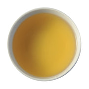 A close-up of steeped Tung Ting. The liquid is a warm, caramel color.