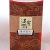 The Bai Hao box is dark red, with golden designs of dragons twisting over it. In the middle is a golden band, with text that reads "Taiwan, 1936. Oriental Beauty Tea." There are Chinese letters above each of the English translations.