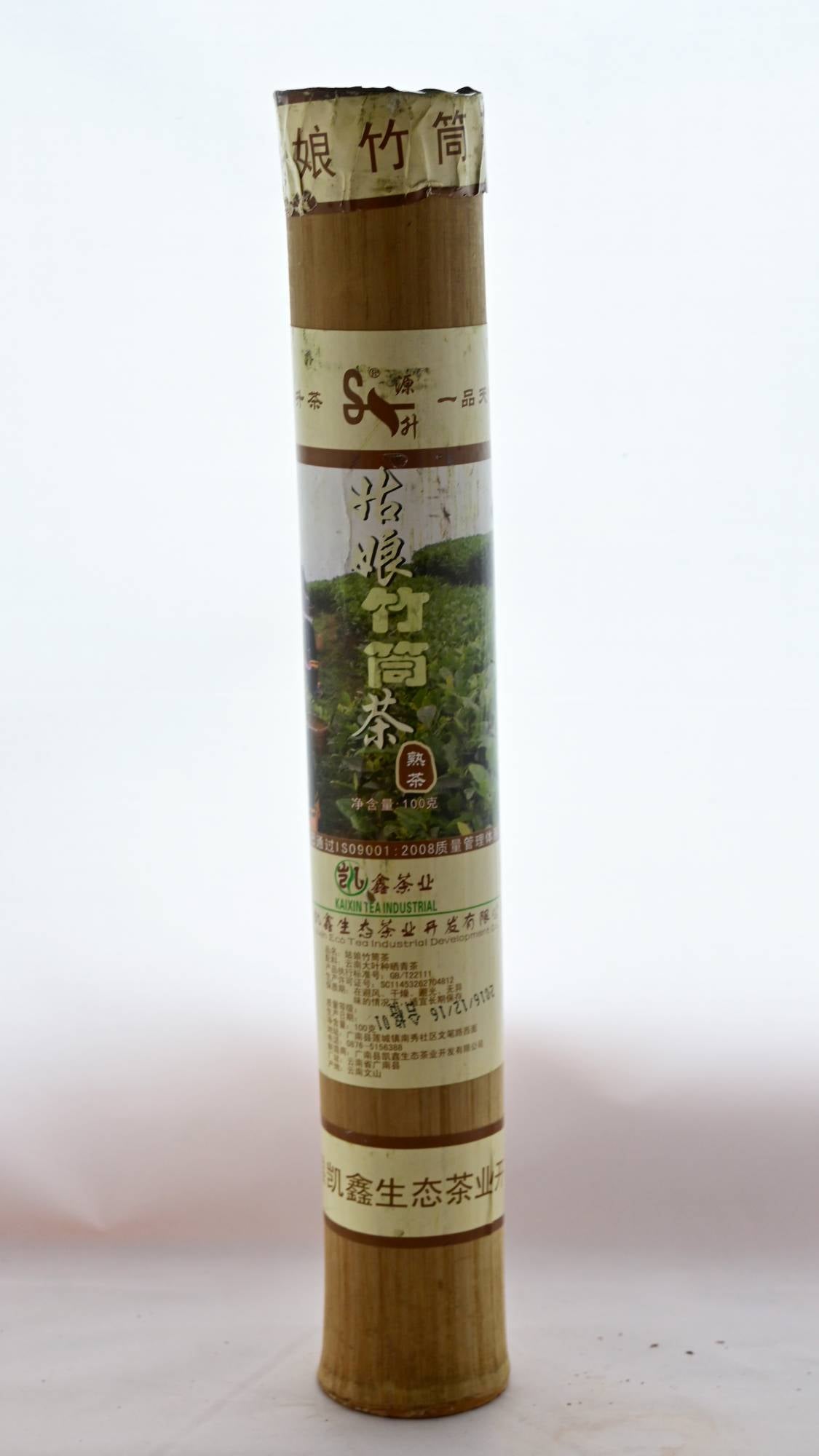 The Bamboo Pu'er container is made of hallow bamboo chute corked on each end with concrete. Packaging wrapping the bamboo segment has an image of tea fields, as well as Chinese lettering.