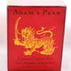 The Ceylon Adam's Peak box is a squat red cube with a lion holding a sword outlined in yellow. Brown lettering reads: "Adam's Peak. Leaves Ceylon Tea. From Nuwara Eliya Area. Packed in Shri Lanka."