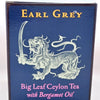 The Earl Grey box is a blue cube with a white lion holding a sword outlined. Yellow and pink text reads: "Eary Grey. Big Leaf Ceylon Tea with Bergamot Oil."