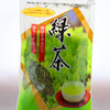 The plastic Kukicha packet prominently features a picture of a growing, green tea bush framed by a diamond in gold. There is a clear spot in the package that shows the stems inside, There are Japanese letters explaining the opening process and resealable nature of the package, as well as the name.