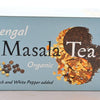 The Bengal Masala Tea box is pastel blue. It features masala spices and rolled black tea together in a yin-yang shape, with black and white peppercorns toward the bottom left. Text reads: "Bengal. Masala Tea. Organic. Black and White Pepper added."