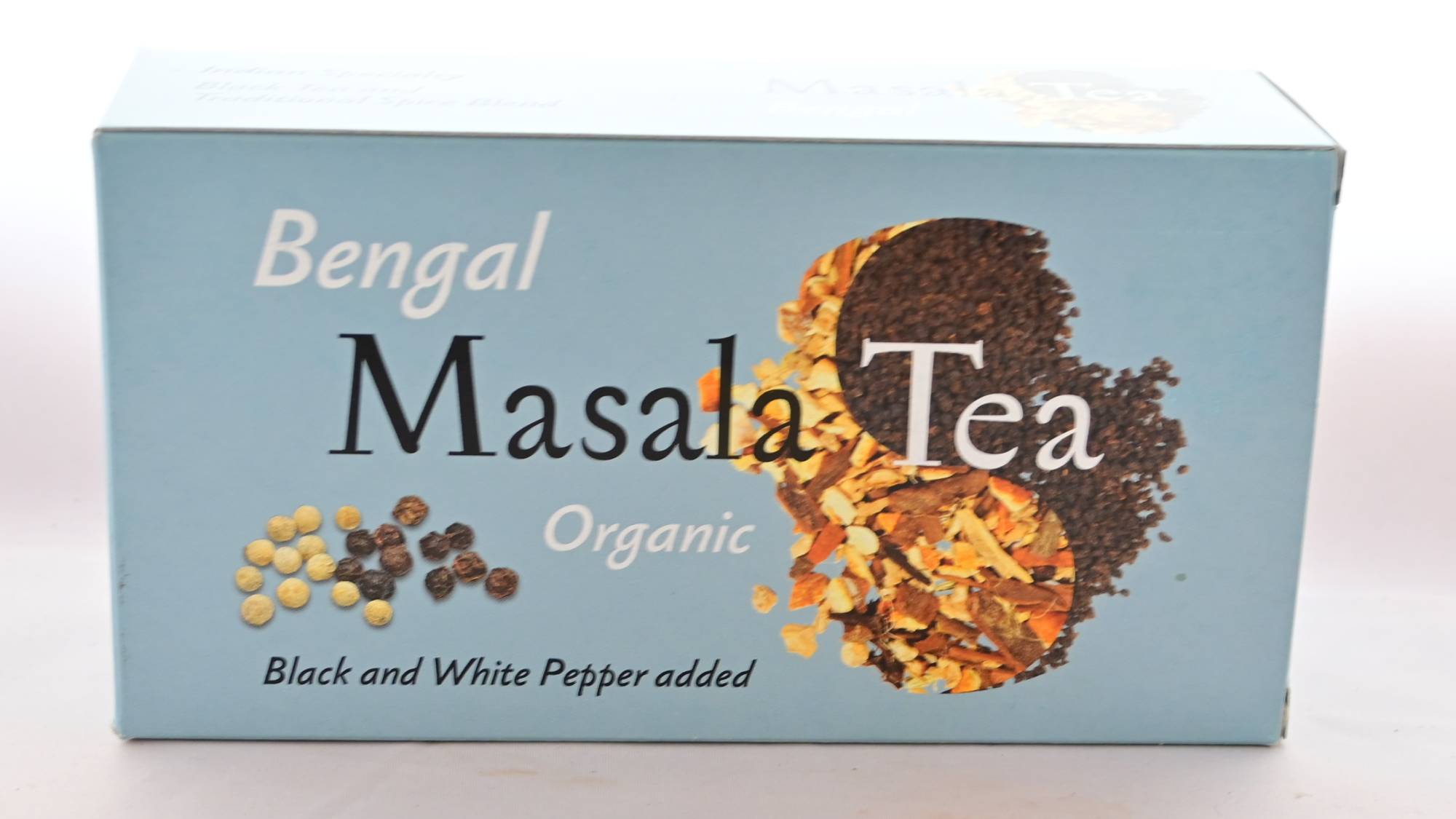 The Bengal Masala Tea box is pastel blue. It features masala spices and rolled black tea together in a yin-yang shape, with black and white peppercorns toward the bottom left. Text reads: "Bengal. Masala Tea. Organic. Black and White Pepper added."