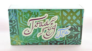 The Touareg box is predominantly green, with Moroccan designs tiled across it. Curly lettering in brown and blue reads "Touareg Tea". 
