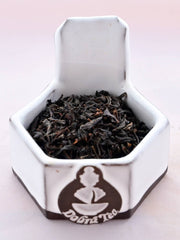 A close-up of Vanilla Tea leaves. The leaves are black, and slightly broken, making them smaller and less curled than other black teas. 