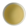 A picture of steeped Ya Bao tea face down. The tea is a creamy, soft off-white color.