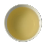 A picture of steeped Ya Bao tea face down. The tea is a creamy, soft off-white color.